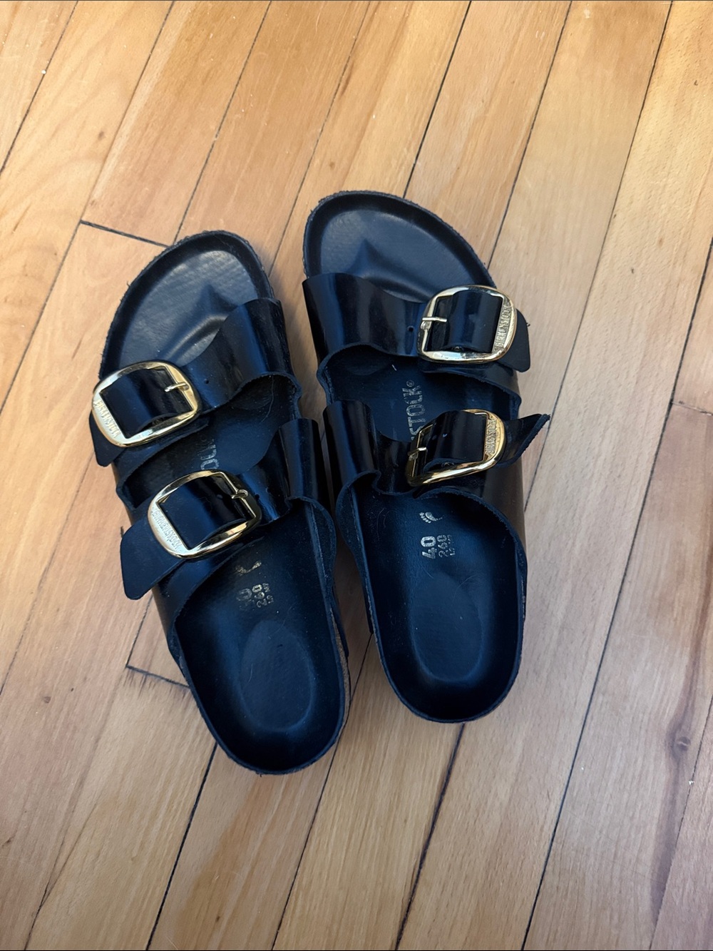 Woman’s Black Double-Buckle Birkenstock Sandals with Gold Buckles
